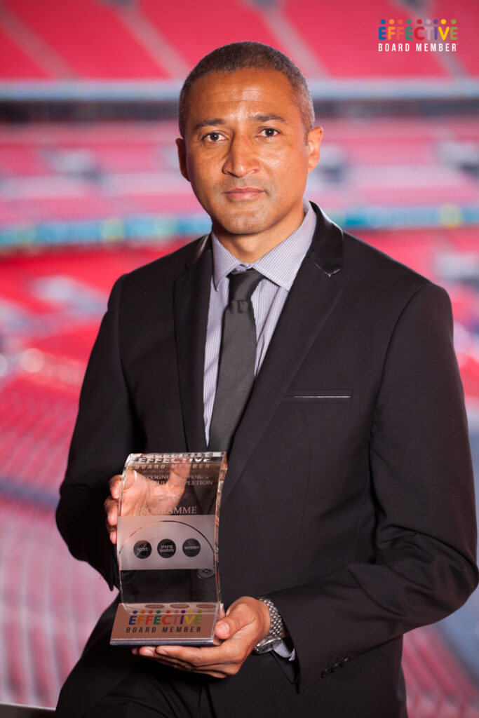 Chris Freestone holding the effective board member programme trophy at Wembley Stadium