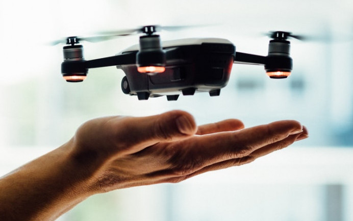 Drones slightly hovering above a persons hand