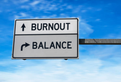 Burnout over balance sign post with blue sky background